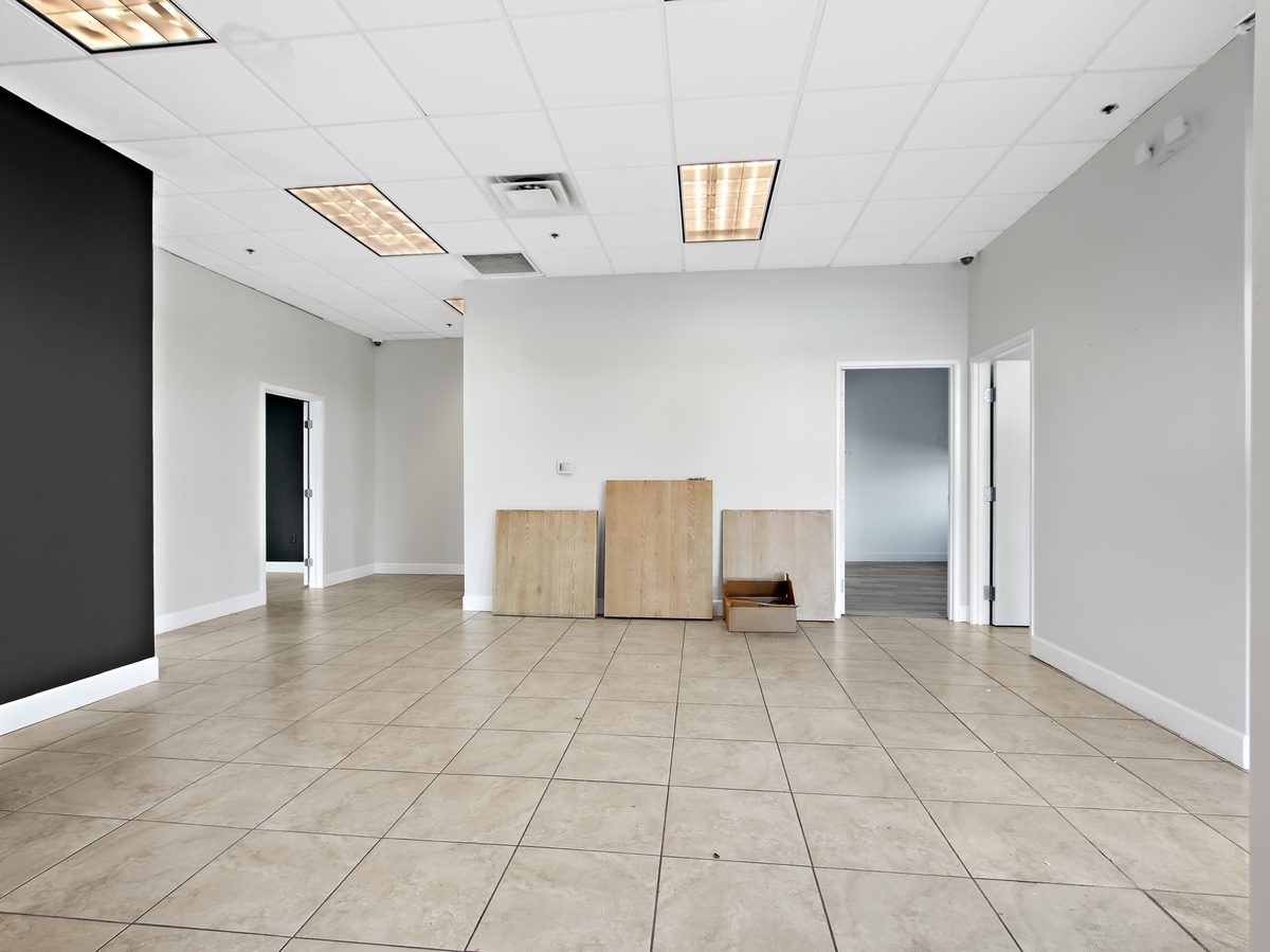 Suite 107: open area with wood-look floor